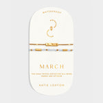March birthstone bracelet set with gold bar charm and light blue crystal beads on display card
