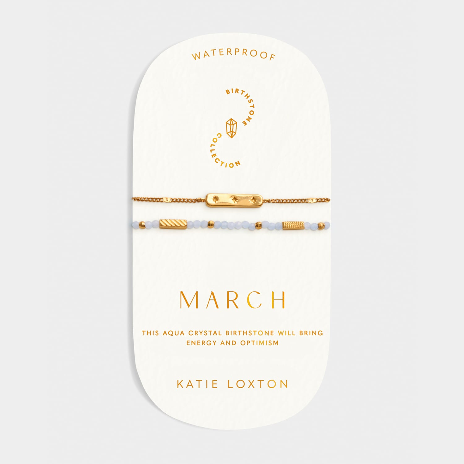 March birthstone bracelet set with gold bar charm and light blue crystal beads on display card