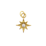 Polished yellow gold eight-point starburst charm with a central round white pearl