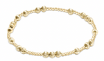 Gold beaded stretch bracelet with alternating smooth and ribbed round beads