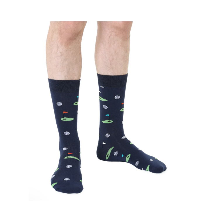 Navy blue crew socks with a repeating pattern of golf balls and putting greens