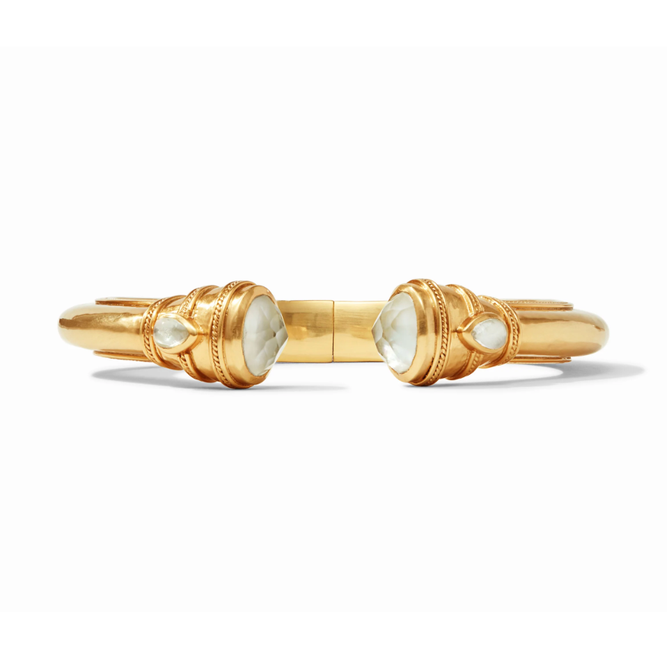 Gold cuff bracelet with two faceted white stones at the opening