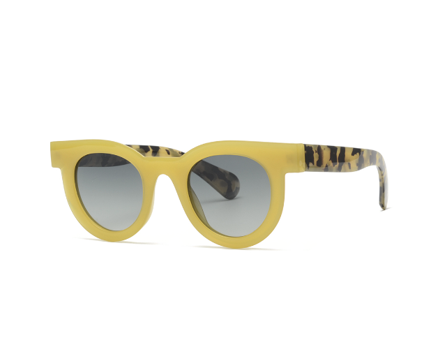 Yellow sunglasses with patterned arms on a white background
