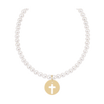 Pearl necklace with a gold circular pendant featuring a cutout cross
