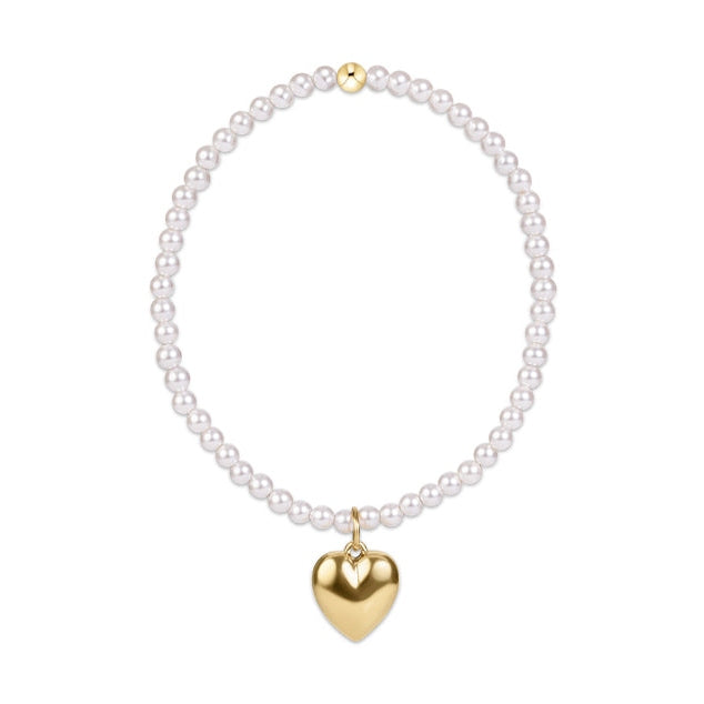 Pearl beaded bracelet with a gold heart charm and a single gold bead