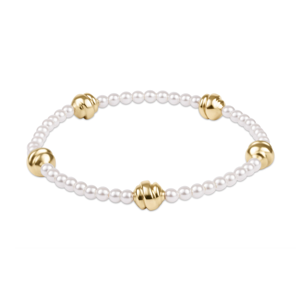 Stretch bracelet with white pearls and four gold beads