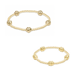 Two gold beaded stretch bracelets with larger ribbed accent beads