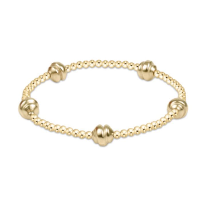 Gold beaded stretch bracelet with four larger ribbed accent beads