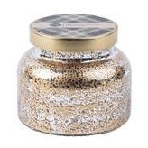 A mercury glass jar candle with a gold lid on a white background