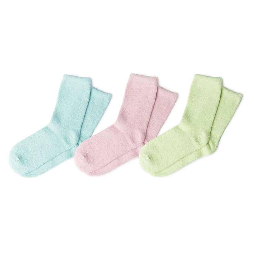 Three pairs of fuzzy crew socks in light blue pink and light green