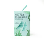Light green box of moisturizing spa socks with aloe vera plant illustrations