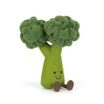 Plush toy by Jellycat, a friendly green broccoli plush sitting on a white background, featuring textured dark green florets, a light green body with an embroidered smiling face and small brown corduroy feet