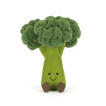 Plush toy of a bright green broccoli stuffed animal with textured florets an embroidered happy face and small brown feet