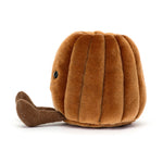 Plush toy of a smiling brown ribbed pumpkin character with small black bead eyes and an embroidered mouth, featuring corduroy legs, sitting on a white background