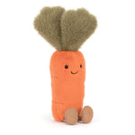 Jellycat plush toy of an orange carrot with fuzzy green leaves, embroidered smiling face, and small tan feet against a white background