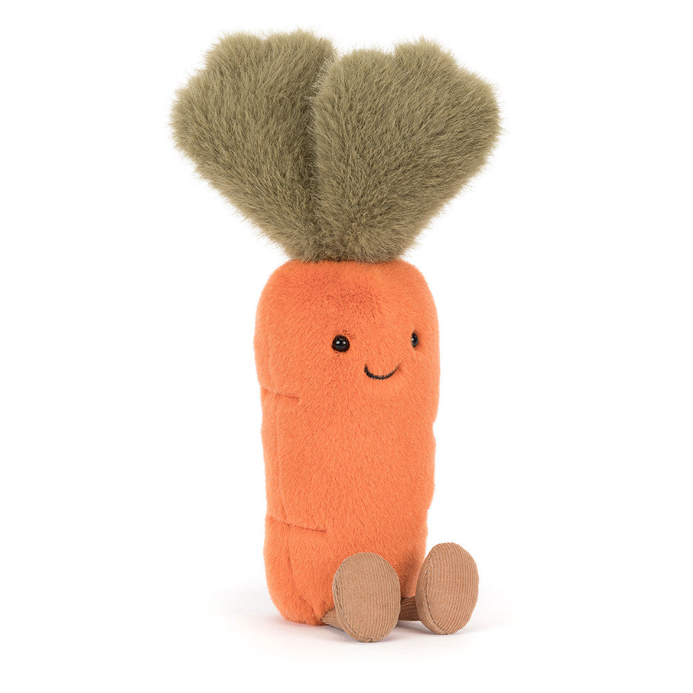 Jellycat plush toy of an orange carrot with fuzzy green leaves, embroidered smiling face, and small tan feet against a white background