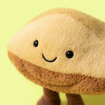 Tan and brown plush toy shaped like a mushroom with a smiling face