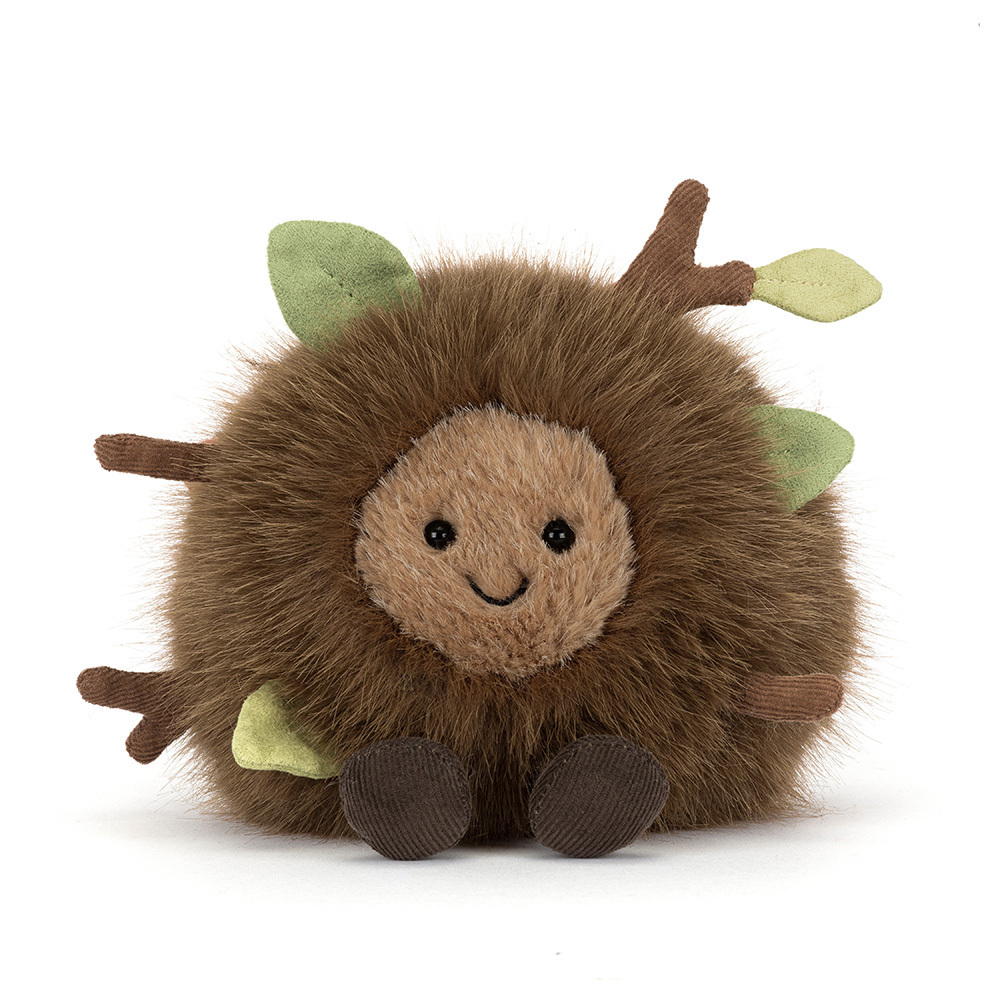 Round brown plush toy with twig and leaf accents