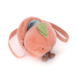 Fuzzy peachy-pink peach-shaped plush bag with a green leaf accent, tiny brown feet, an open zipper revealing light blue patterned lining, and a pink adjustable strap