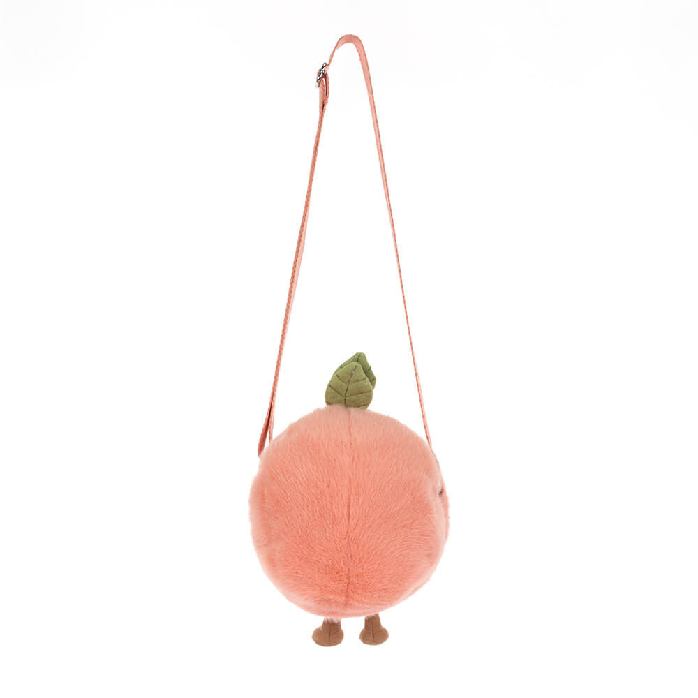 A plush novelty bag in a fluffy peachy-pink round design featuring a green leaf accent tiny brown feet and a thin pink shoulder strap
