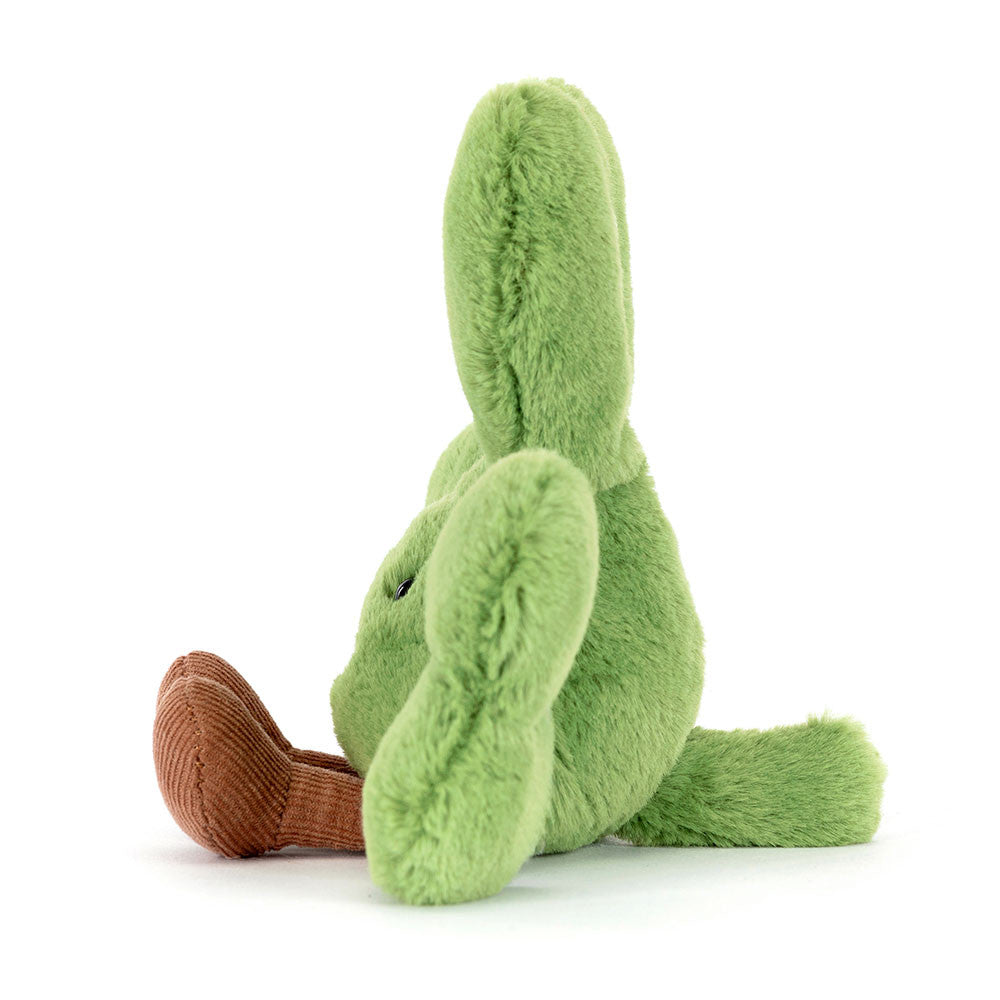 Fluffy green plush toy rabbit with long ears and distinct brown corduroy feet sits facing left on a pure white background a small black eye visible