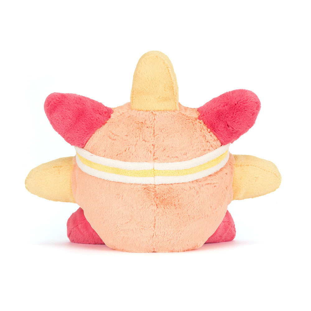 Back view of a peach and pink plush toy with yellow accents