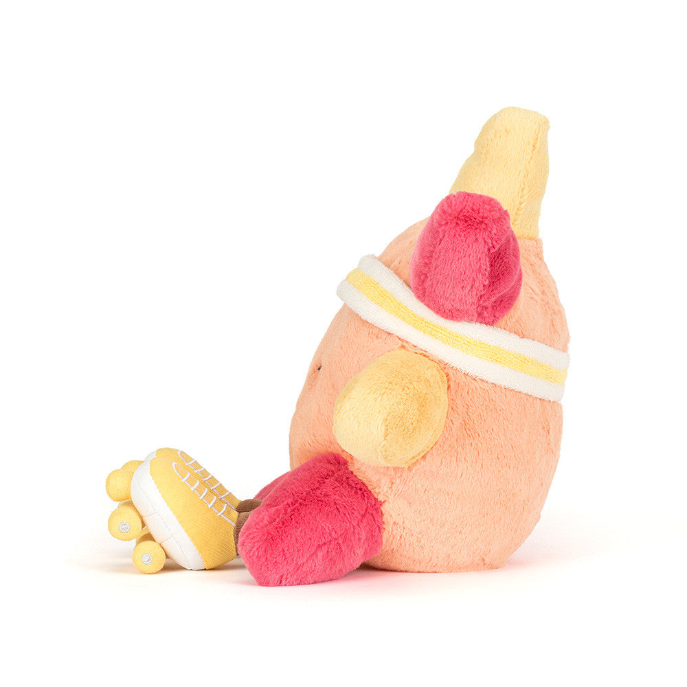 Plush toy shaped like a peach wearing a headband and yellow roller skates