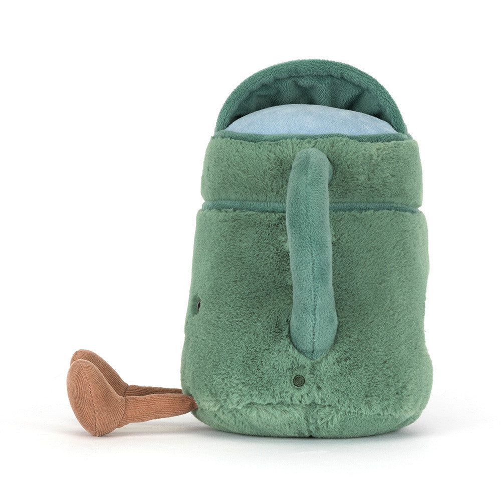 Fuzzy green plush toy in the shape of a watering can featuring a light blue opening and tan corduroy legs resting on a plain white background