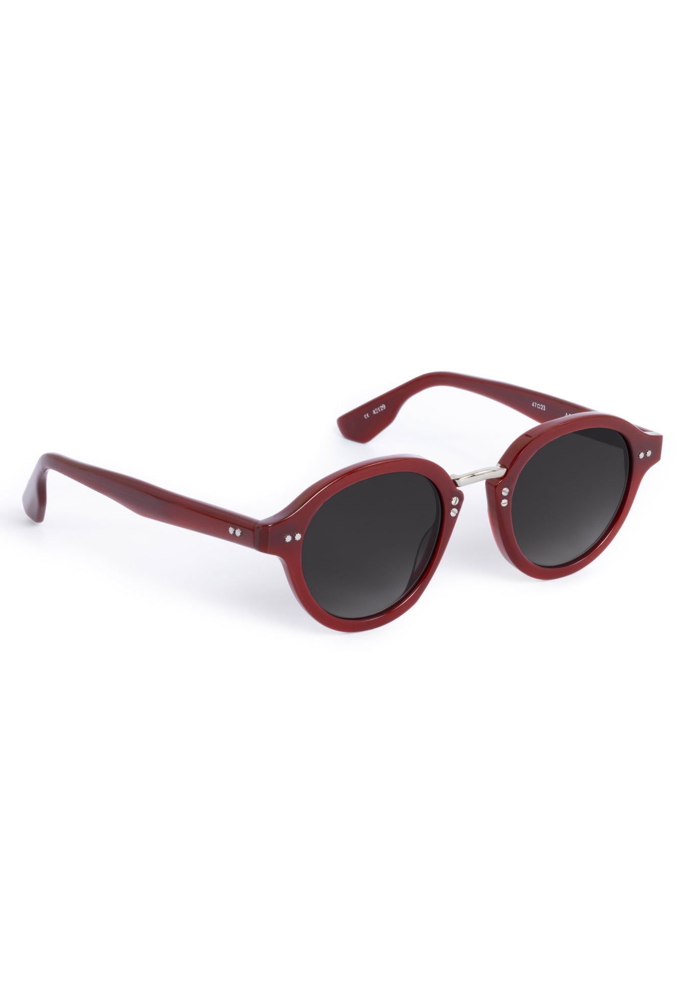 Product photograph of dark red round sunglasses with dark grey tinted lenses, silver hinge details, and small stud accents on the temples and front, displaying model numbers 47023 and 42129 on the arms against a clean white background