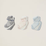 three sets of baby socks in grey and white stipe, pink and white stripe, and blue and white stripe on a taupe background