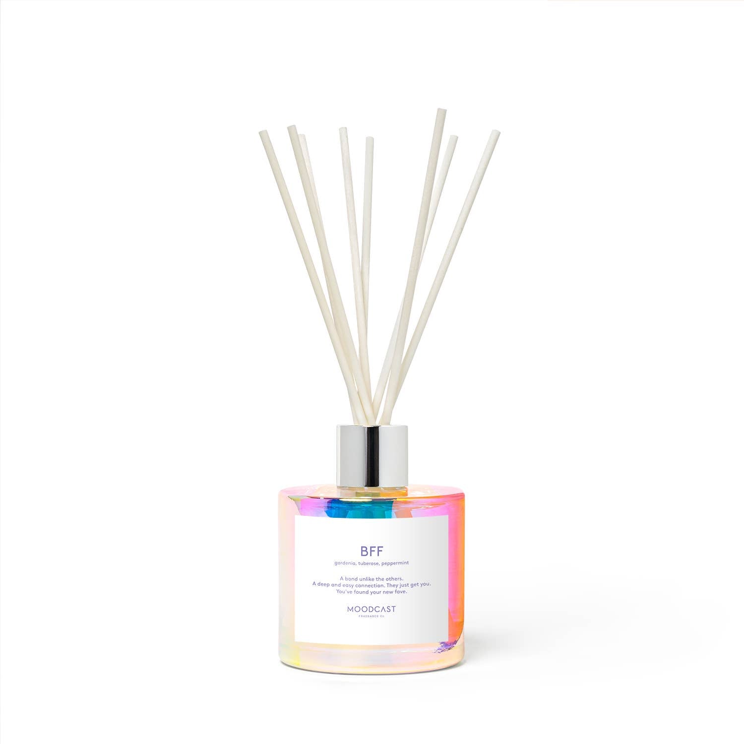 Iridescent glass reed diffuser with white reeds and a white label