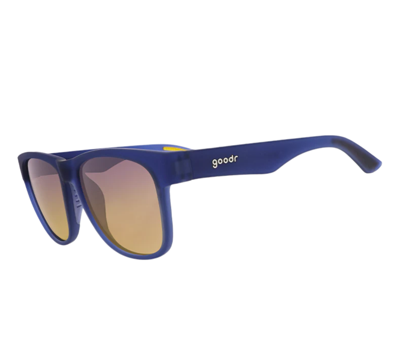 Product photography of goodr sunglasses with matte blue frames yellow-orange gradient lenses and subtle yellow temple accents