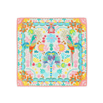 Textile design showcasing a symmetrical vibrant tropical pattern featuring two facing macaws, a central stylized palm tree, abundant pink and yellow flowers, and blue-green pineapples within a dynamic scalloped and geometric border