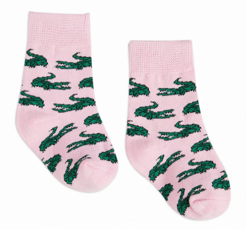 Textile, Lacoste pair of pink socks with a repeating green crocodile logo pattern and ribbed cuffs