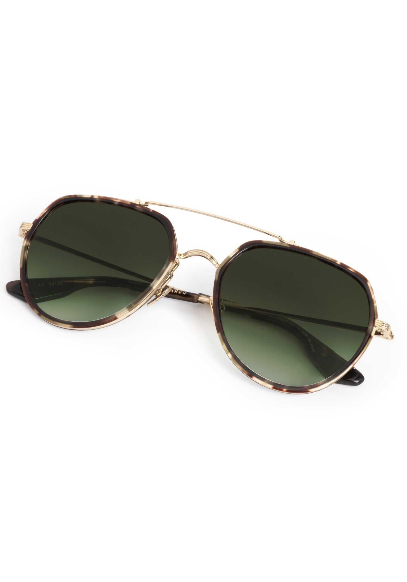 Product photography of sunglasses featuring tortoiseshell octagonal frames, green gradient lenses, and a gold-tone double bridge, designed in New Orleans