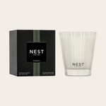 Nest New York Bamboo scented candle set featuring a black box with green striped accents and a white candle in a clear glass votive with frosted vertical stripes