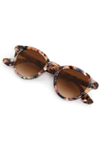 Product photo of feather-patterned sunglasses featuring cream brown black and blue frames with gradient brown lenses on a clean white background