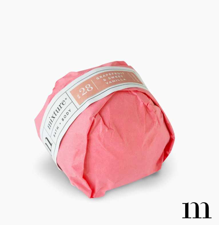 Pink wrapped bath bomb with label reading Mixture No 28 Grapefruit and Sweet Vanilla