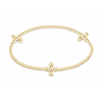 A radiant gold beaded bracelet forming an oval with three distinct cross designs made from larger polished gold beads on a clean white background