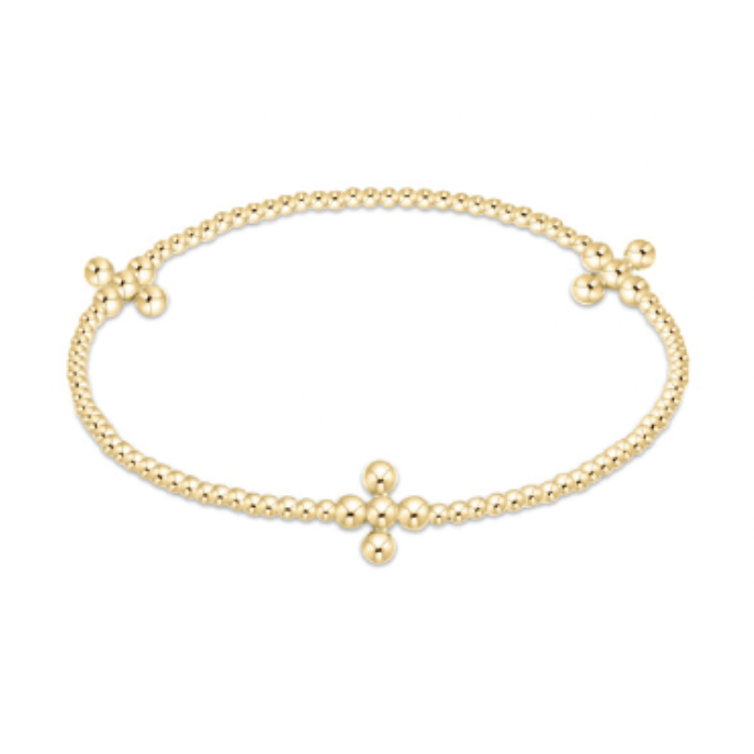 A radiant gold beaded bracelet forming an oval with three distinct cross designs made from larger polished gold beads on a clean white background
