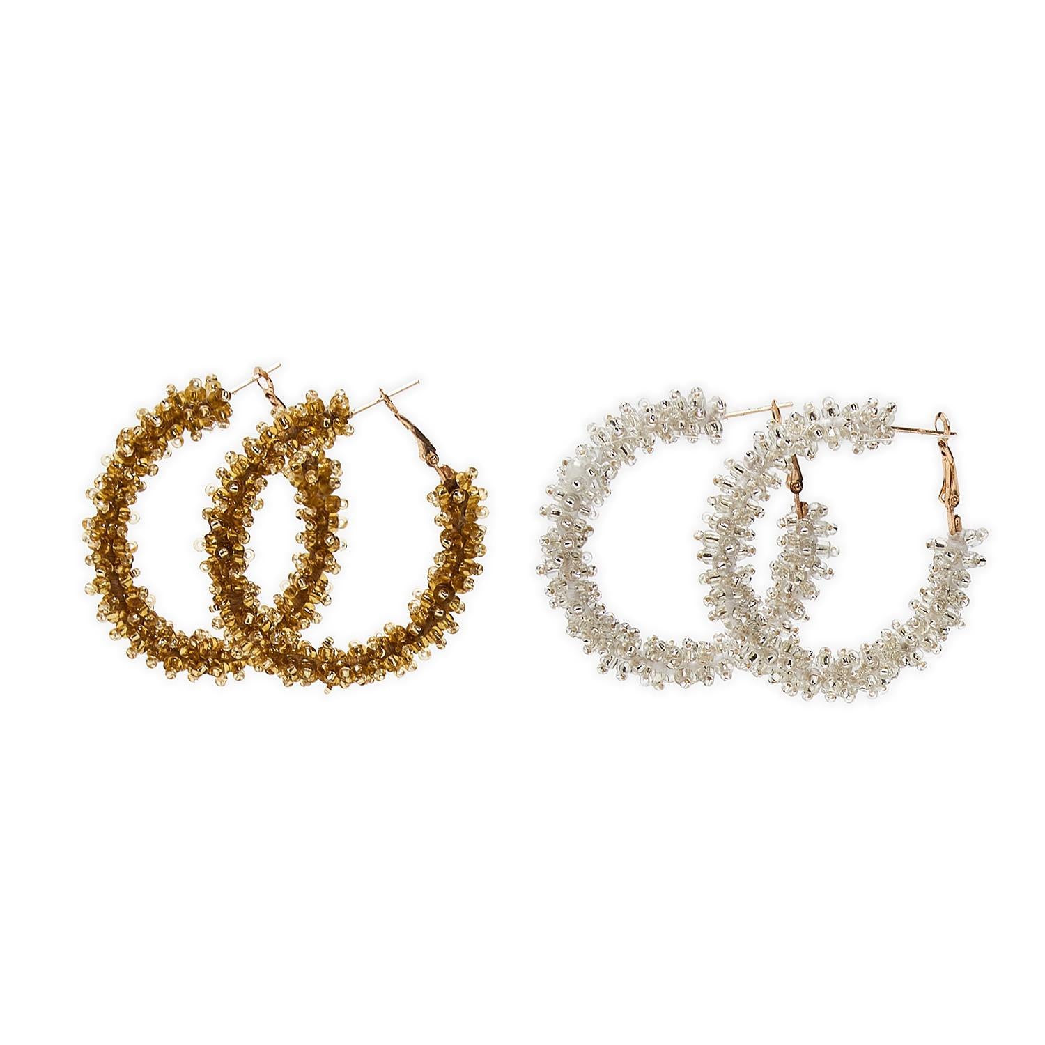 Two pairs of beaded hoop earrings in gold and silver