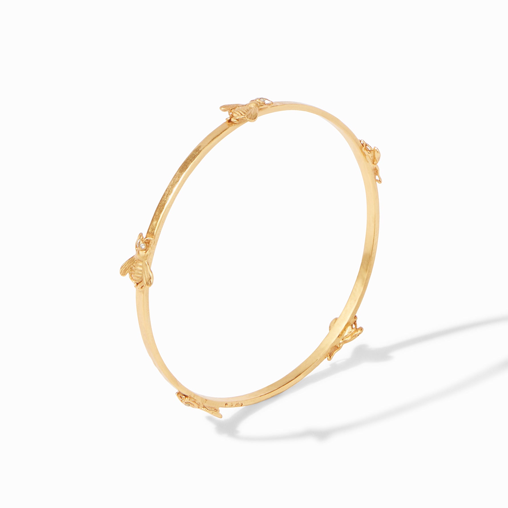 Gold bangle bracelet featuring small bee accents
