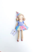 Mudpie plush doll Lily the Birthday Bestie on a white background wearing a colorful rainbow tutu, a shimmering pink birthday hat, and sparkly pink ballet slippers