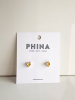 Yellow heart shaped stud earrings on a Phina branded display card