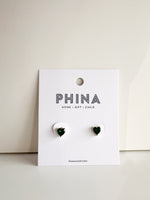 Green heart shaped stud earrings on a Phina branded display card