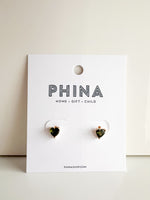 Pair of heart shaped green stone stud earrings on a white display card