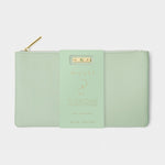 Katie Loxton pastel green faux leather pouch with a gold zipper and a decorative paper band detailing 'AUGUST BIRTHSTONE COLLECTION' and Aventurine
