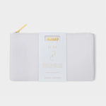 Product photo by Katie Loxton of a white textured vegan leather pouch with a gleaming gold zipper, featuring a prominent white tag displaying the word June in gold, and text describing the Moonstone birthstone collection