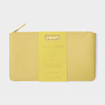 Katie Loxton bright yellow faux leather pouch featuring a gold zipper and a central yellow tag with "NOVEMBER" and two star icons describing Yellow Quartz properties of happiness and peace