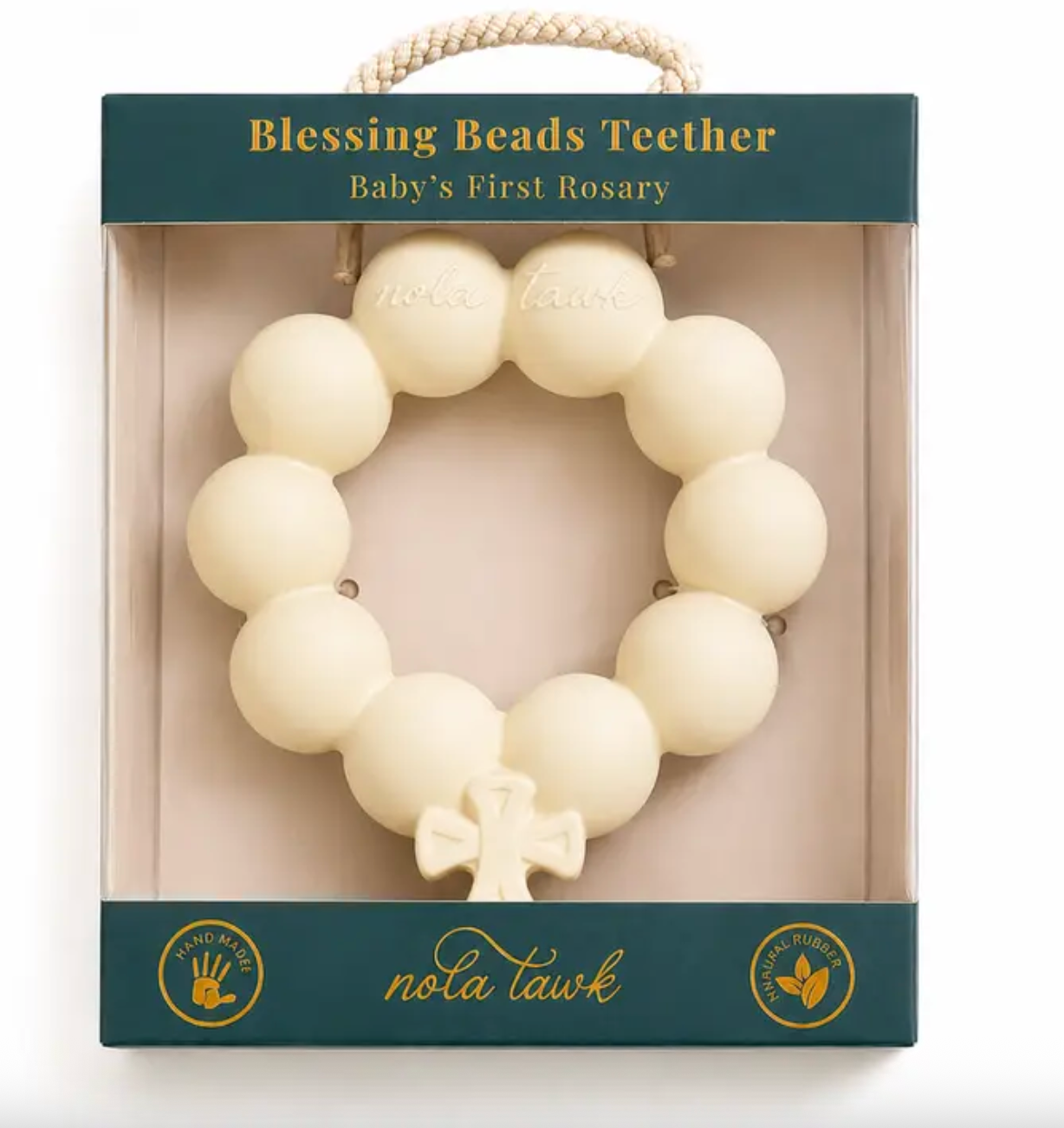 Cream colored circular rubber baby teether with cross charm in retail packaging
